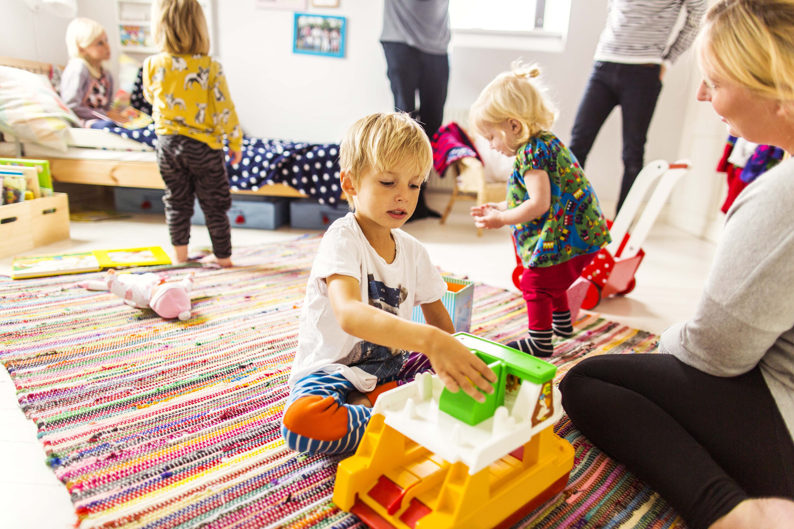 Little children engaged in playtime in a colorful room.